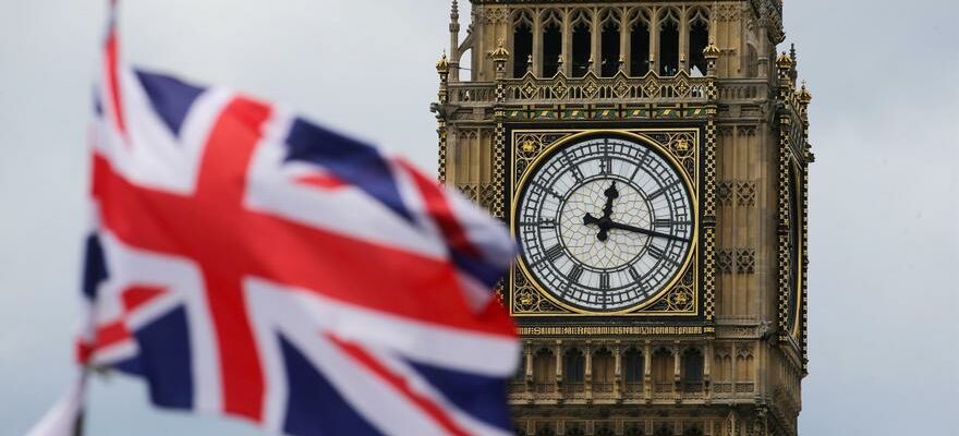 Un homme grimpe la Big Ben Tower portant un drapeau