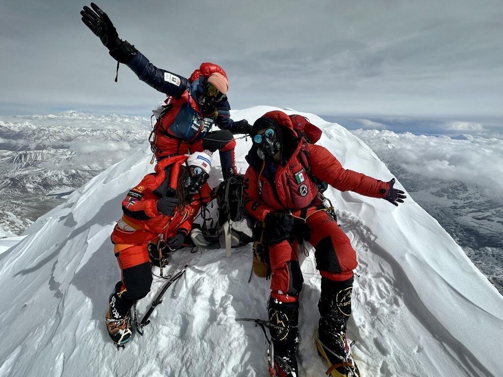 This photograph taken on April 26, 2023 and published on June 26, 2023 shows Norwegian Kristin Harila (bottom left), French, Swiss and Canadian Sophie Lavaud (top left) and Mexican Viridiana Alvarez (right) posing atop Shishapangma Peak in Tibet, the 13ᵉ peak over 8000m that the French have climbed.