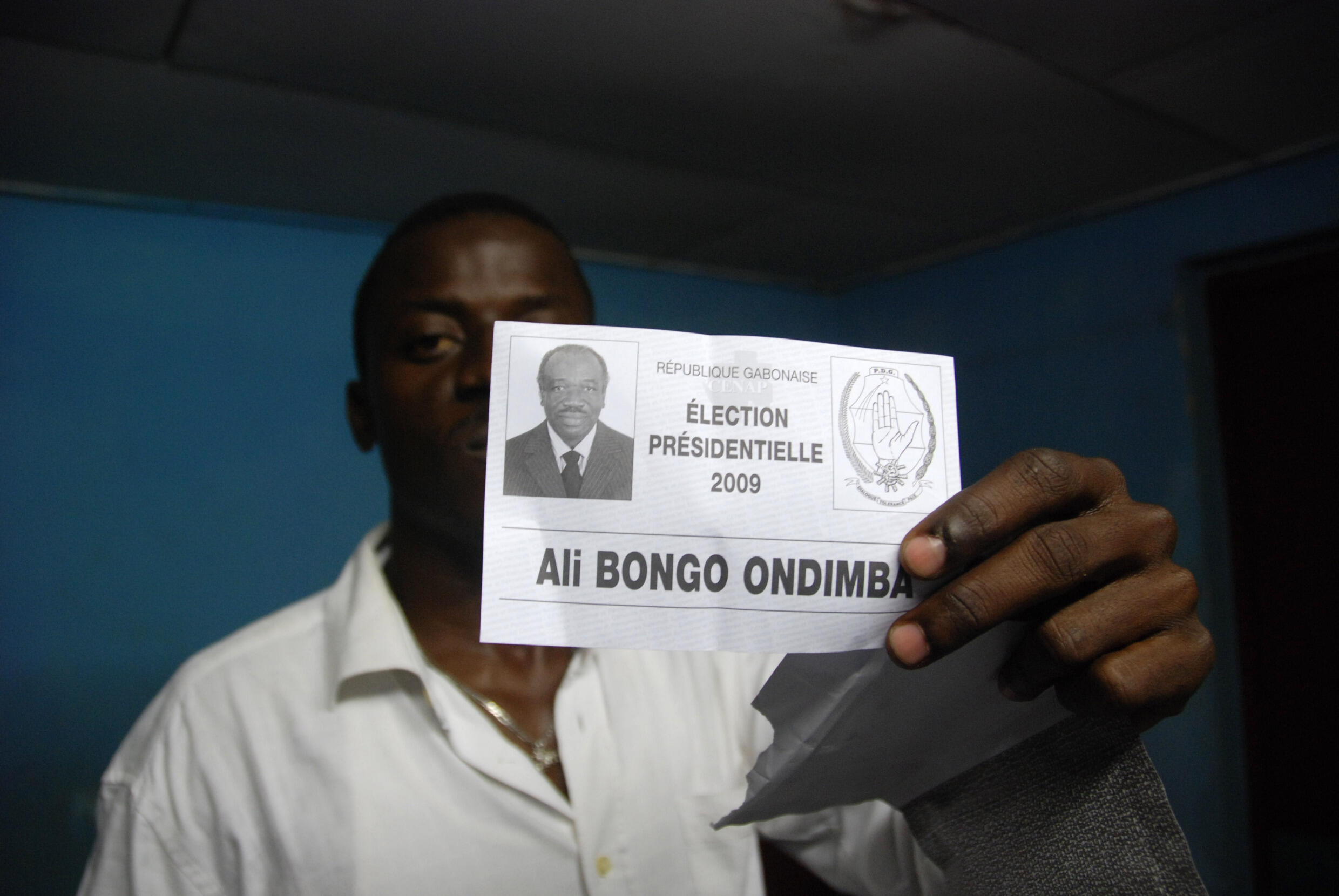 An electoral worker holds up a ballot during the counting of the presidential election at a polling station in Libreville, Gabon August 30, 2009.