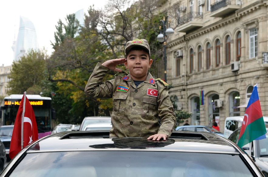Boy in Azerbaijan army uniform during celebrations in Baku on November 10, 2020, after the agreement with Armenia to fight in Nagorno Karabakh