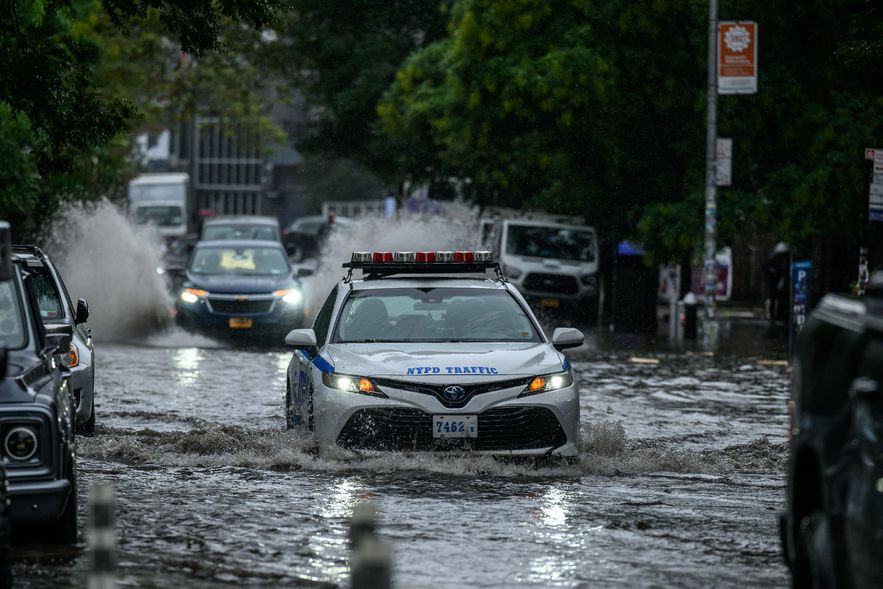 Cars struggle on flooded roads after heavy rains in the Brooklyn borough of New York on September 29, 2023.