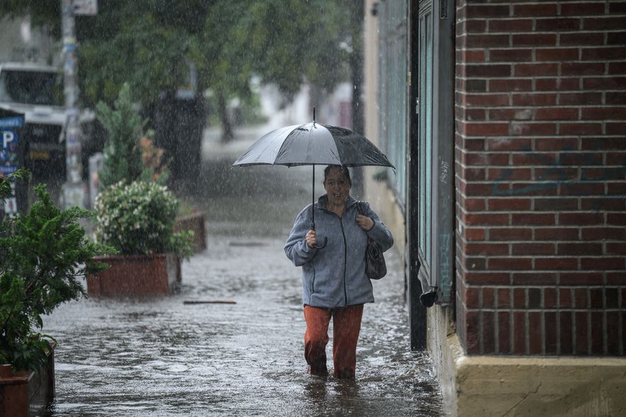 A resident walks in a flooded street in Brooklyn, after heavy rains in New York, September 29, 2023 