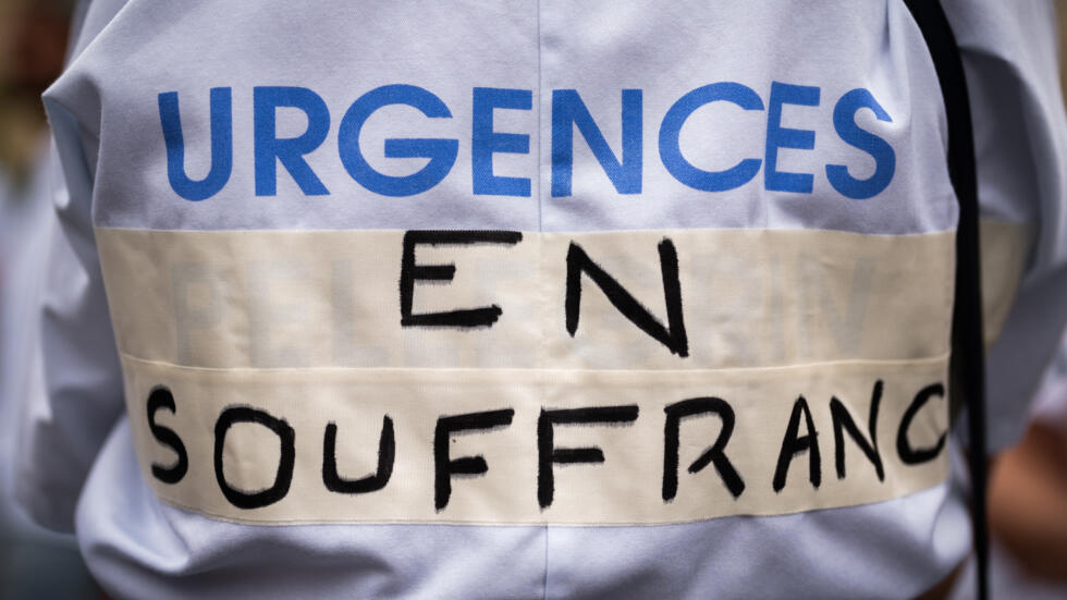 A slogan “Emergency overdue” on the blouse of a member of a Bordeaux hospital during a demonstration, June 7, 2022.