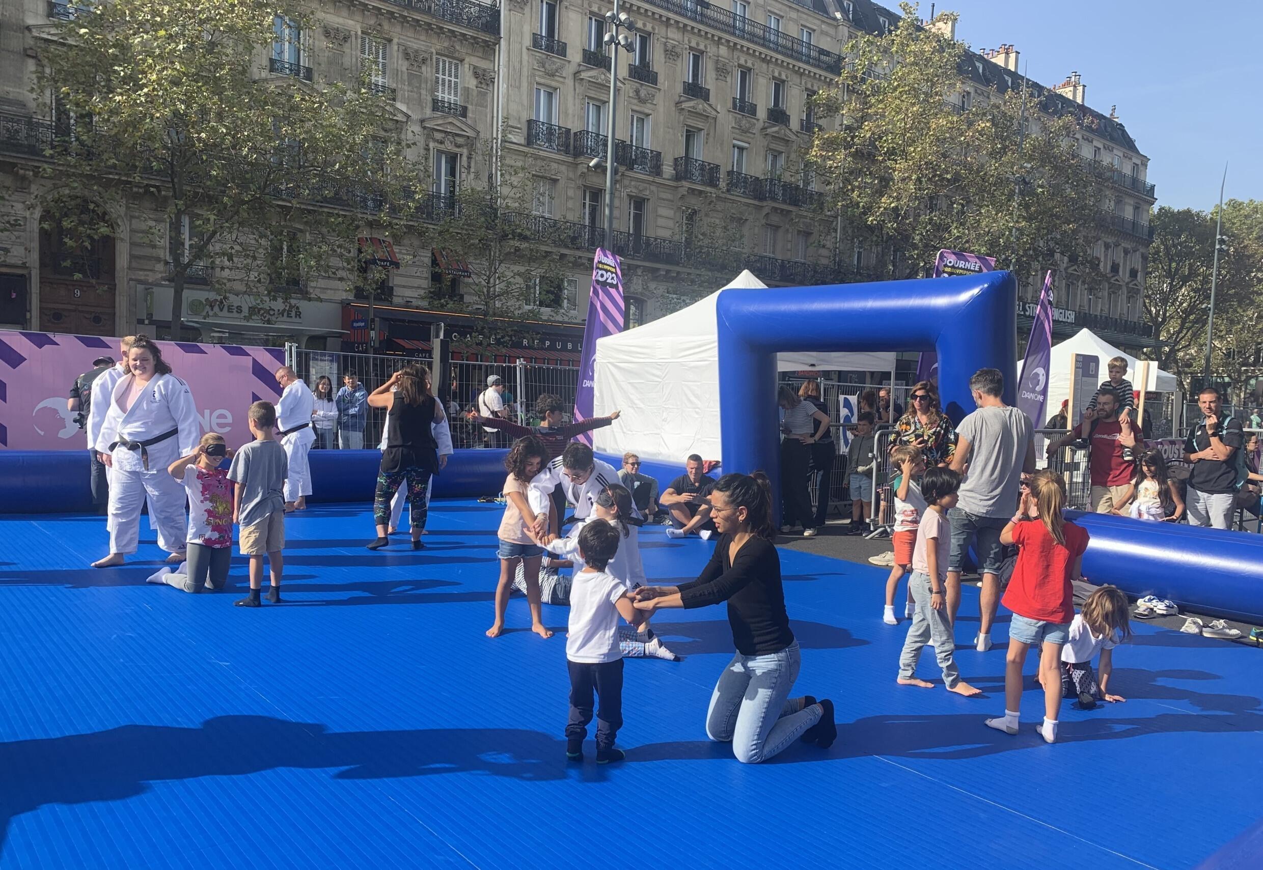 Young and old try their hand at blindfolded judo during the Paralympic day organized at Place de la République in Paris, October 8, 2023.