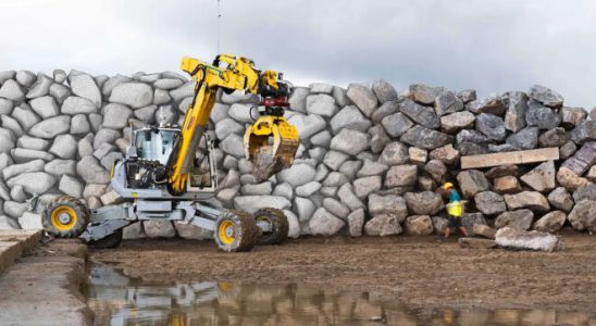 A walking excavator that can build walls from large rocks