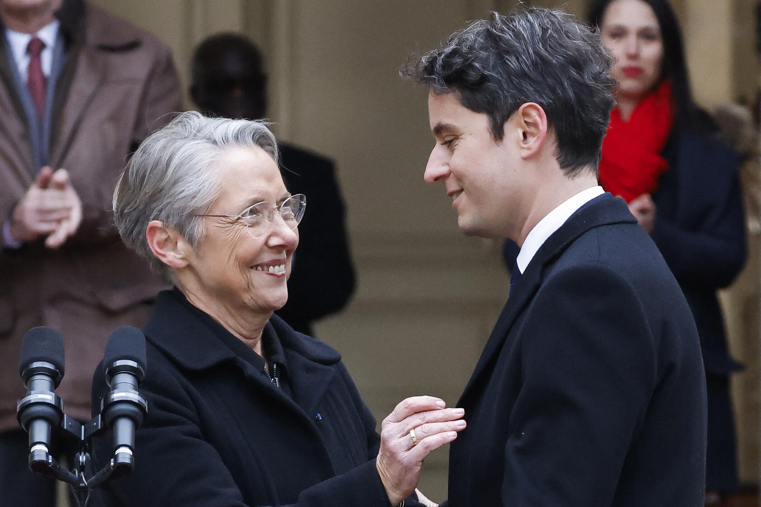New Prime Minister Gabriel Attal greets outgoing Prime Minister Élisabeth Borne at the end of the transfer of power ceremony at the Matignon Hotel in Paris, January 9, 2024.