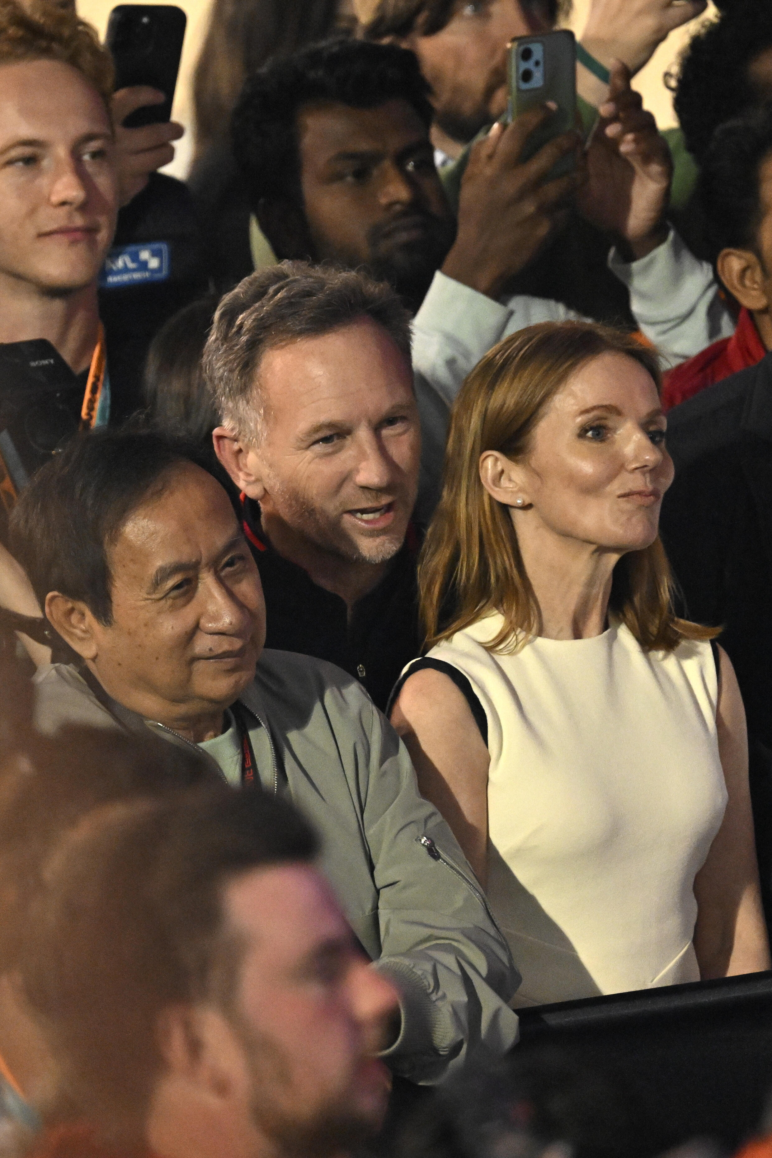 Red Bull Racing team principal Christian Horner, his wife, British singer Geri Halliwell, ChalermYoovidhya attend the podium ceremony of the Formula 1 Bahrain Grand Prix at the Bahrain International Circuit in Sakhir on March 2, 2024
