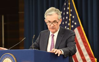 Fed Powell more balanced risks but warns inflation remains too