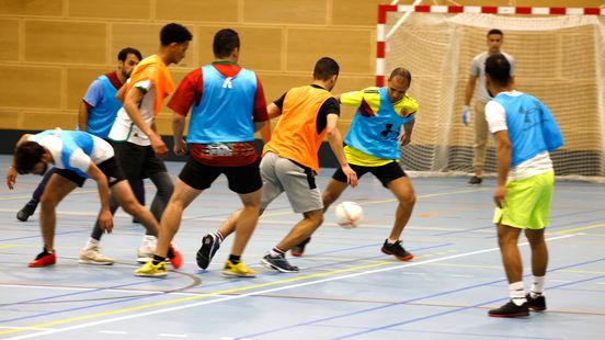Refugees play football against each other in Utrecht sports hall