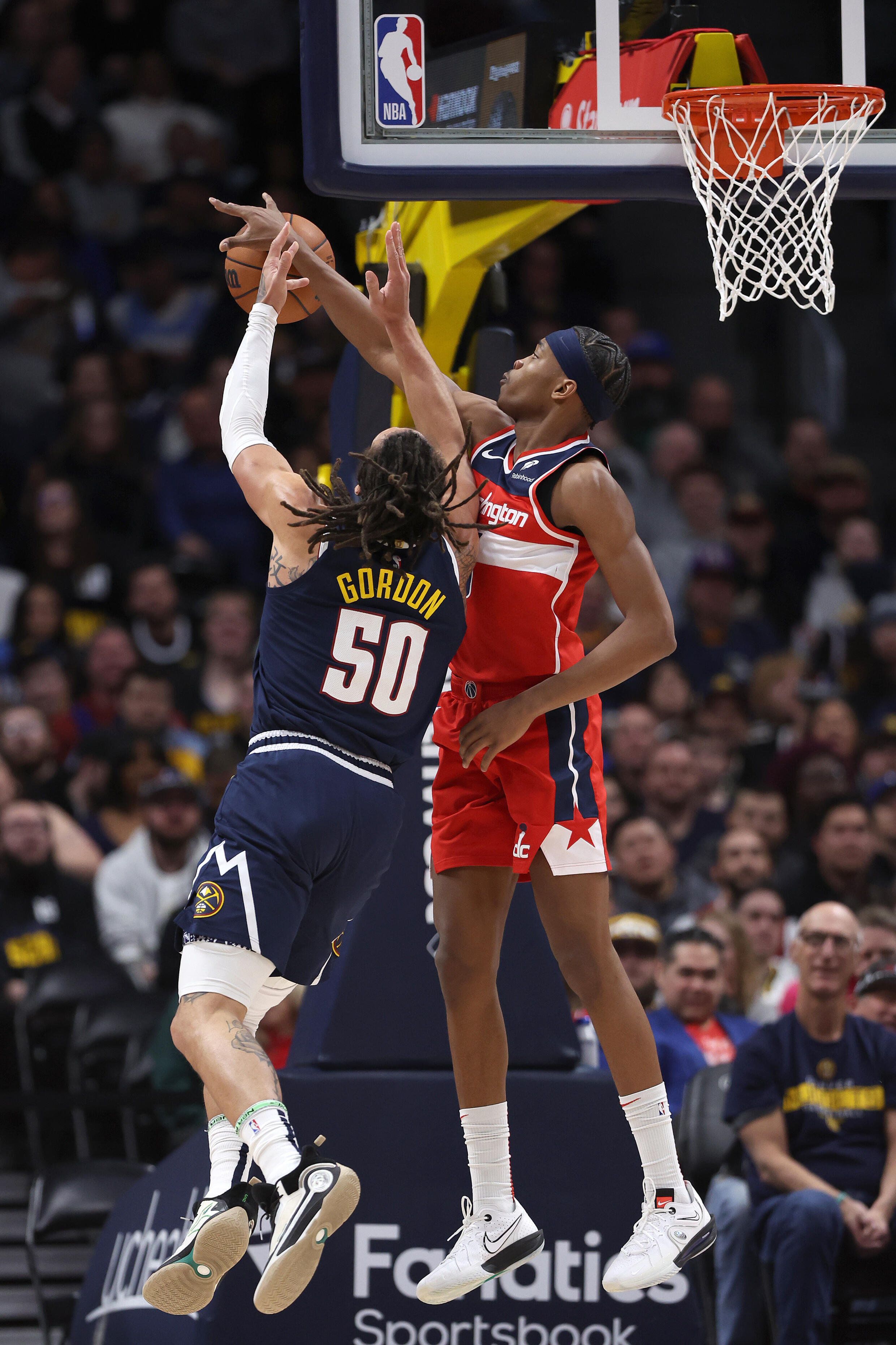 Washington Wizards French winger Bilal Coulibaly (D) counters against Nuggets star Aaron Gordon (#50) during an NBA regular season game on February 22, 2024 in Denver