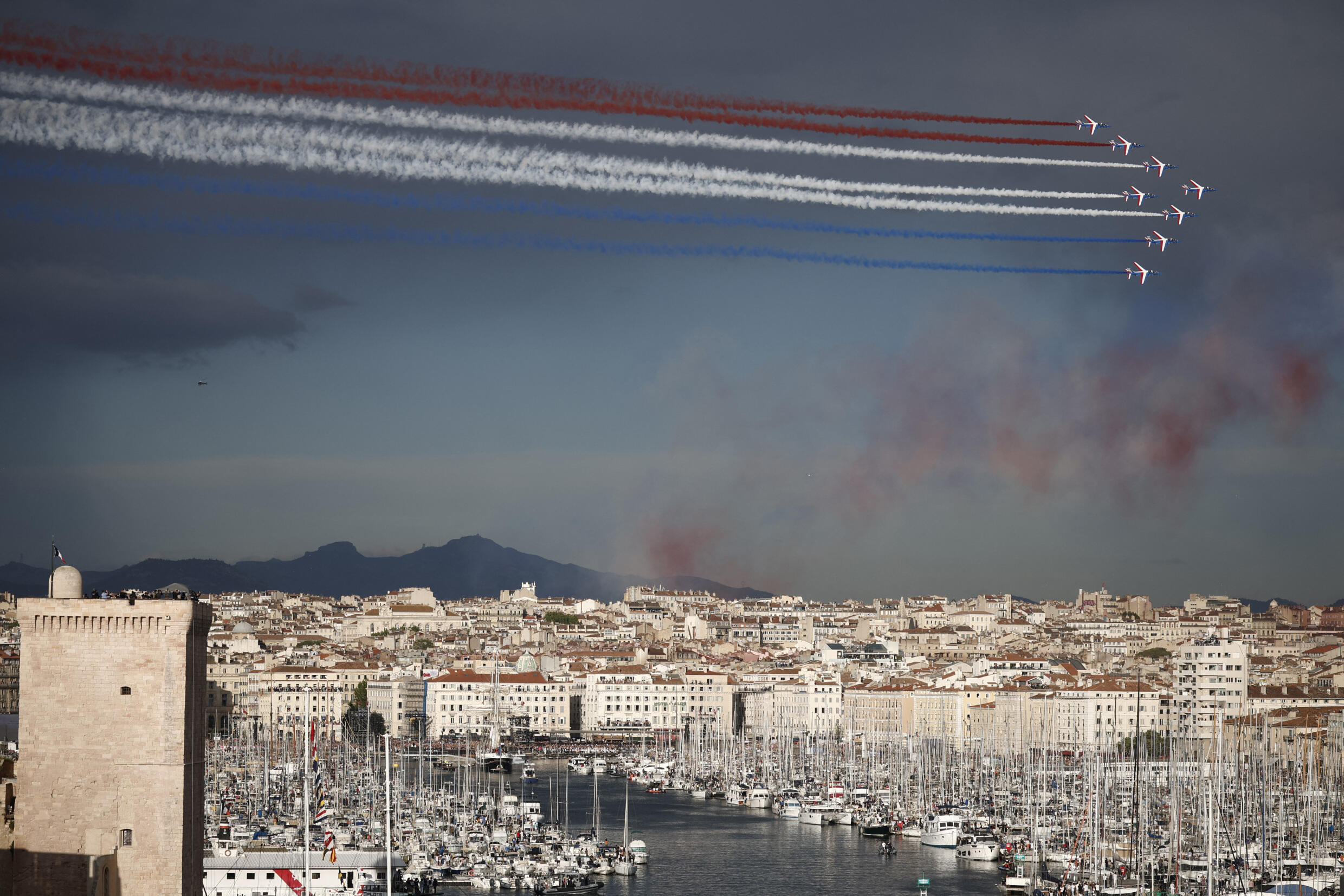 Patrouille de France planes release smoke in the colors of the French flag as the Belem approaches the Old Port ahead of the Paris 2024 Olympic Games. Marseille, France, May 8, 2024.