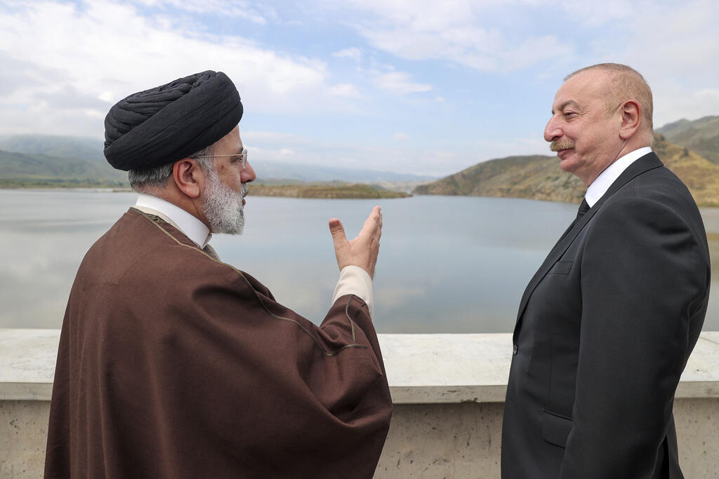 In this photo published by the Iranian presidential office, President Ebrahim Raïssi (left) speaks with his Azeri counterpart Ilham Aliev on the occasion of the inauguration of the Qiz Qalasi dam on the border with Iran and Azerbaijan, Sunday May 19, 2024.
