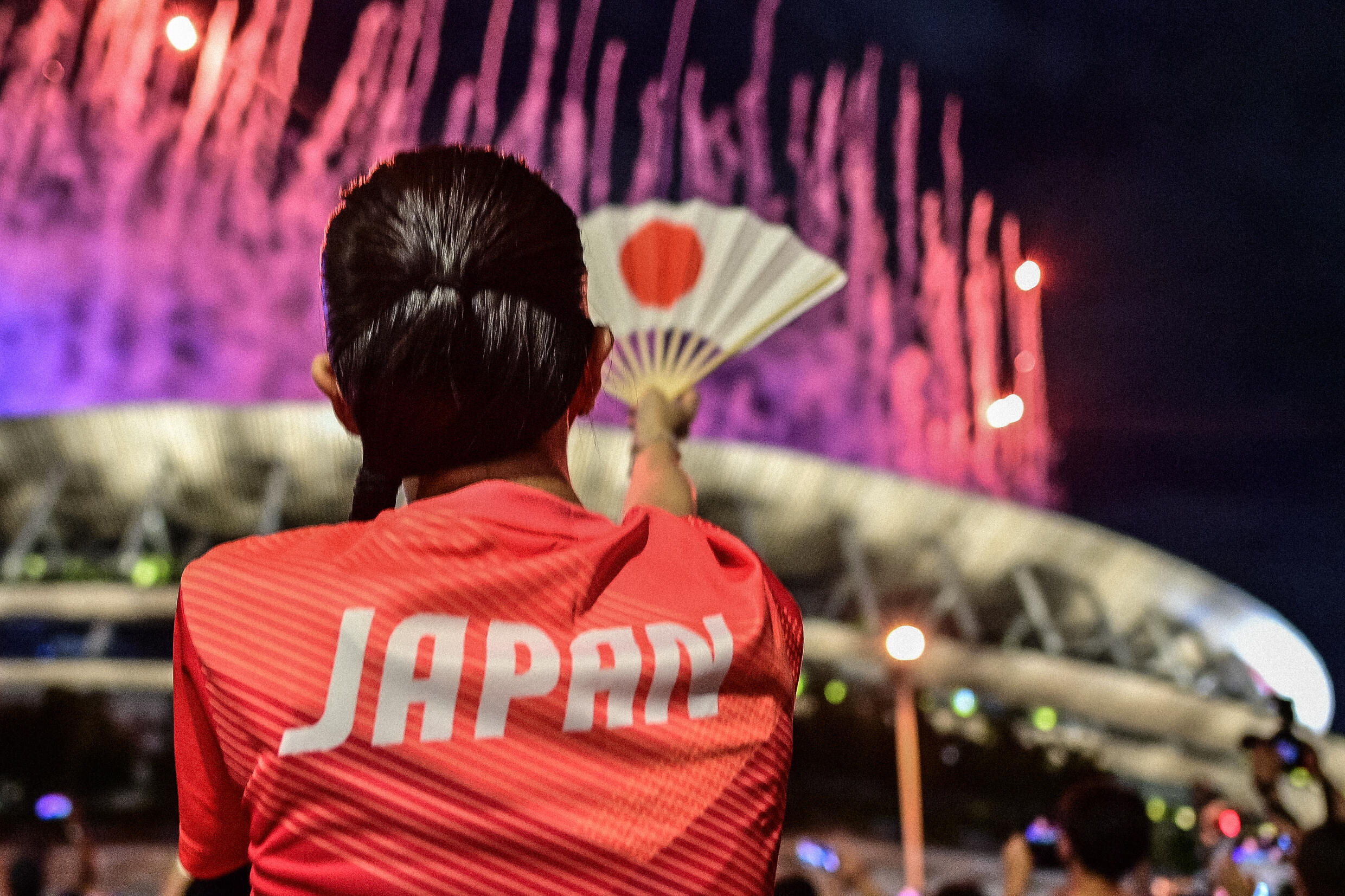 A Japanese fan during the fireworks at the Tokyo Olympic Stadium for the opening ceremony of the games on July 23, 2021, Japan