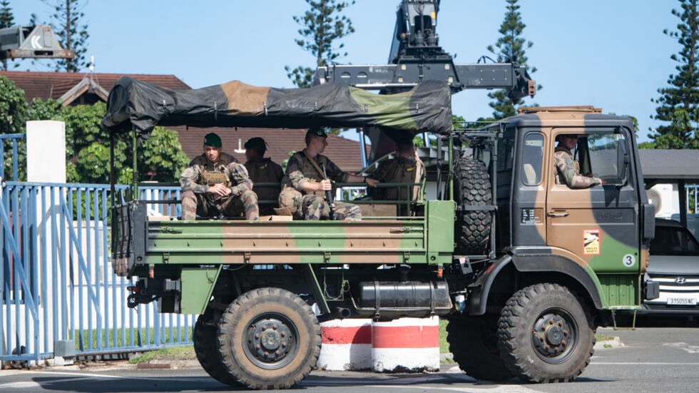 Soldiers of the French Foreign Legion stand in a military vehicle at the entrance to the Autonomous Port of Nouméa, May 31, 2024.
