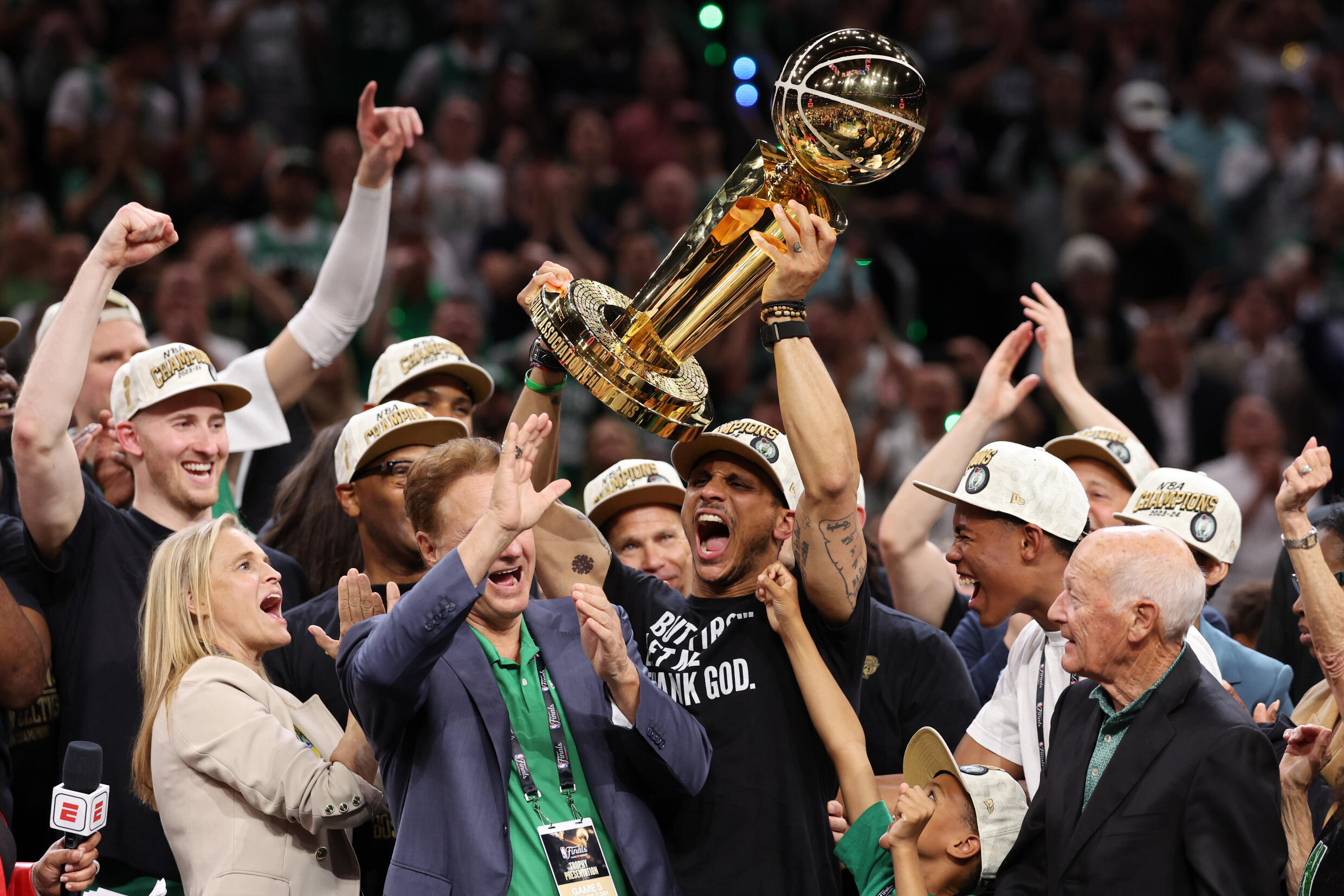 Boston Celtics head coach Joe Mazzulla shouts while lifting the trophy after his team's 106-88 victory over the Dallas Mavericks in Game 5 of the 2024 NBA Finals at TD Garden in Boston on June 17, 2024