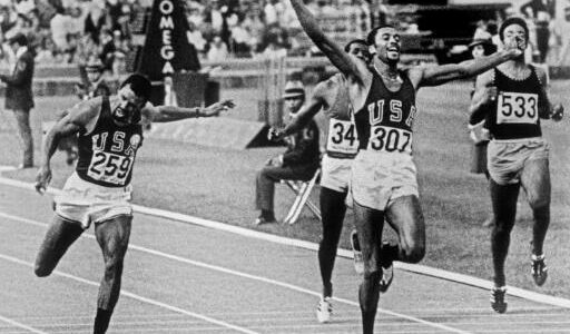 Tommie Smith still with his fist raised