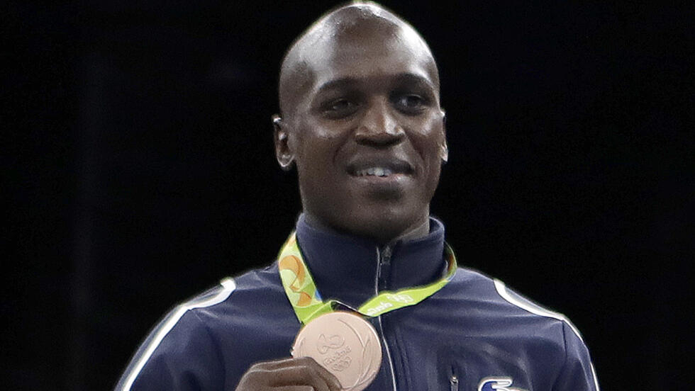 Souleymane Diop Cissokho of France displays his bronze medal in the men's welterweight 69kg boxing final at the 2016 Summer Olympics in Rio de Janeiro, Brazil, Wednesday, Aug. 17, 2016.