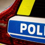 Woman seriously injured after collision with police car
