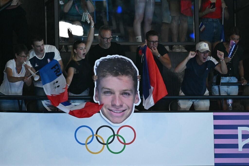 Supporters of French swimmer Léon Marchand with his portrait in the stands of La Défense Arena, July 31, 2024.