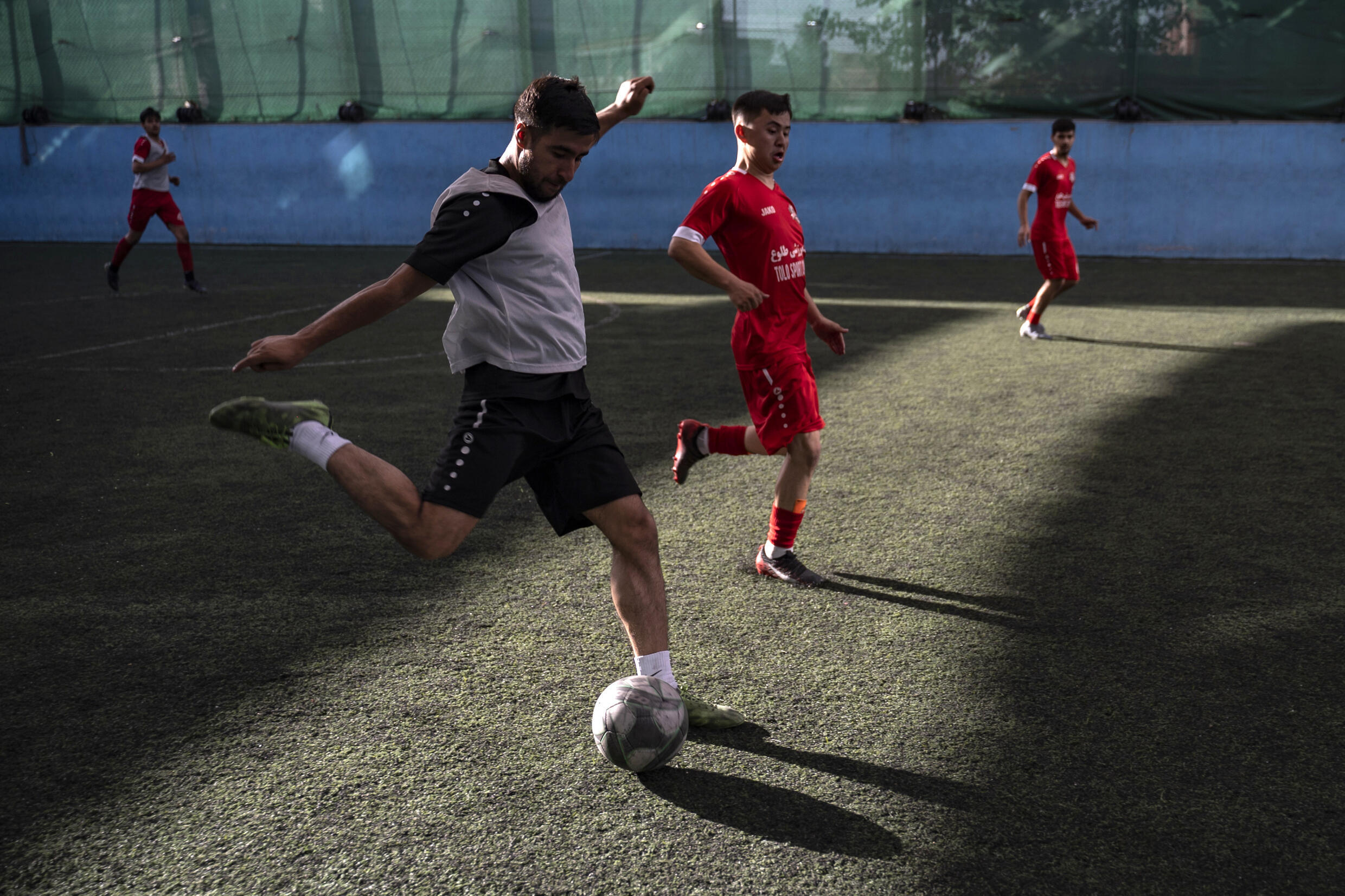 Young Afghans play futsal in a sports complex in Kabul, September 25, 2024