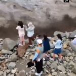 Frightening images from China Waves dragged people from between cliffs