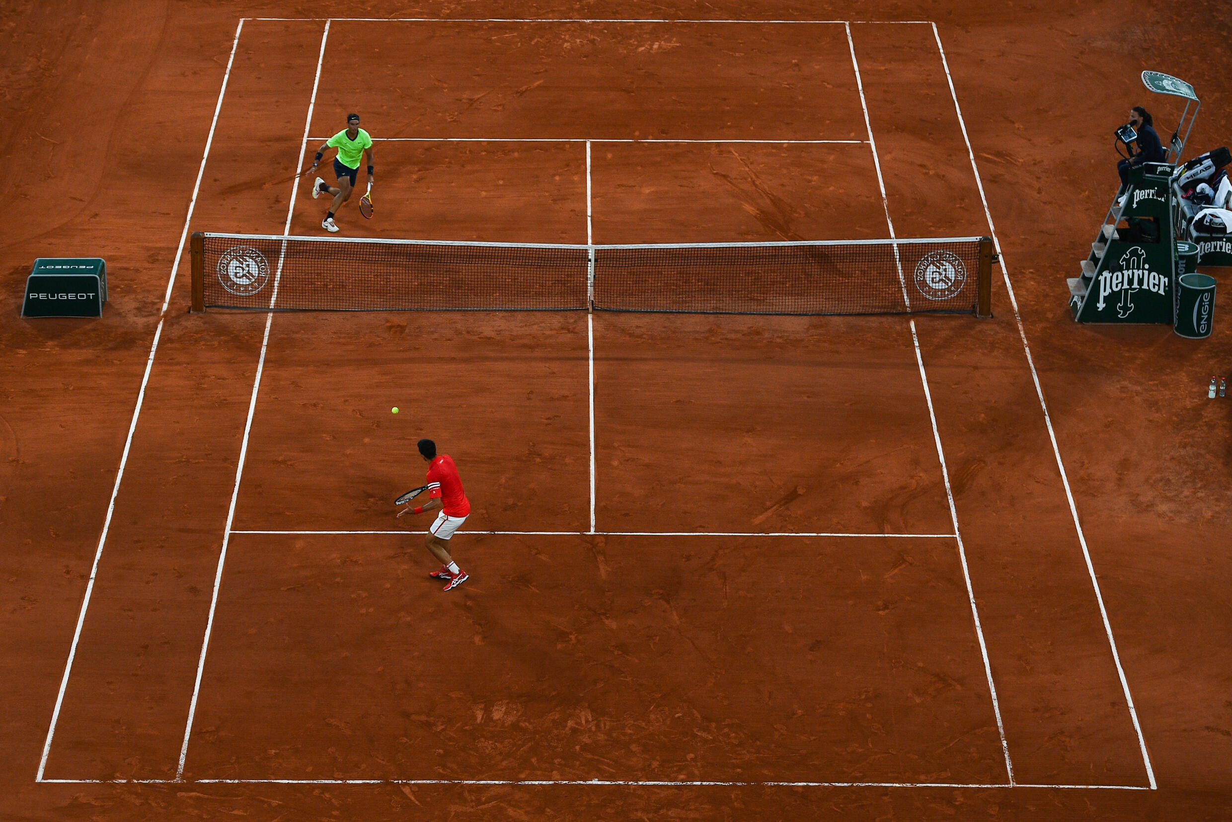 Serbian Novak Djokovic returns the ball to Spaniard Rafael Nadal (top) during their semi-final match at Roland Garros 2021, in Paris, June 11