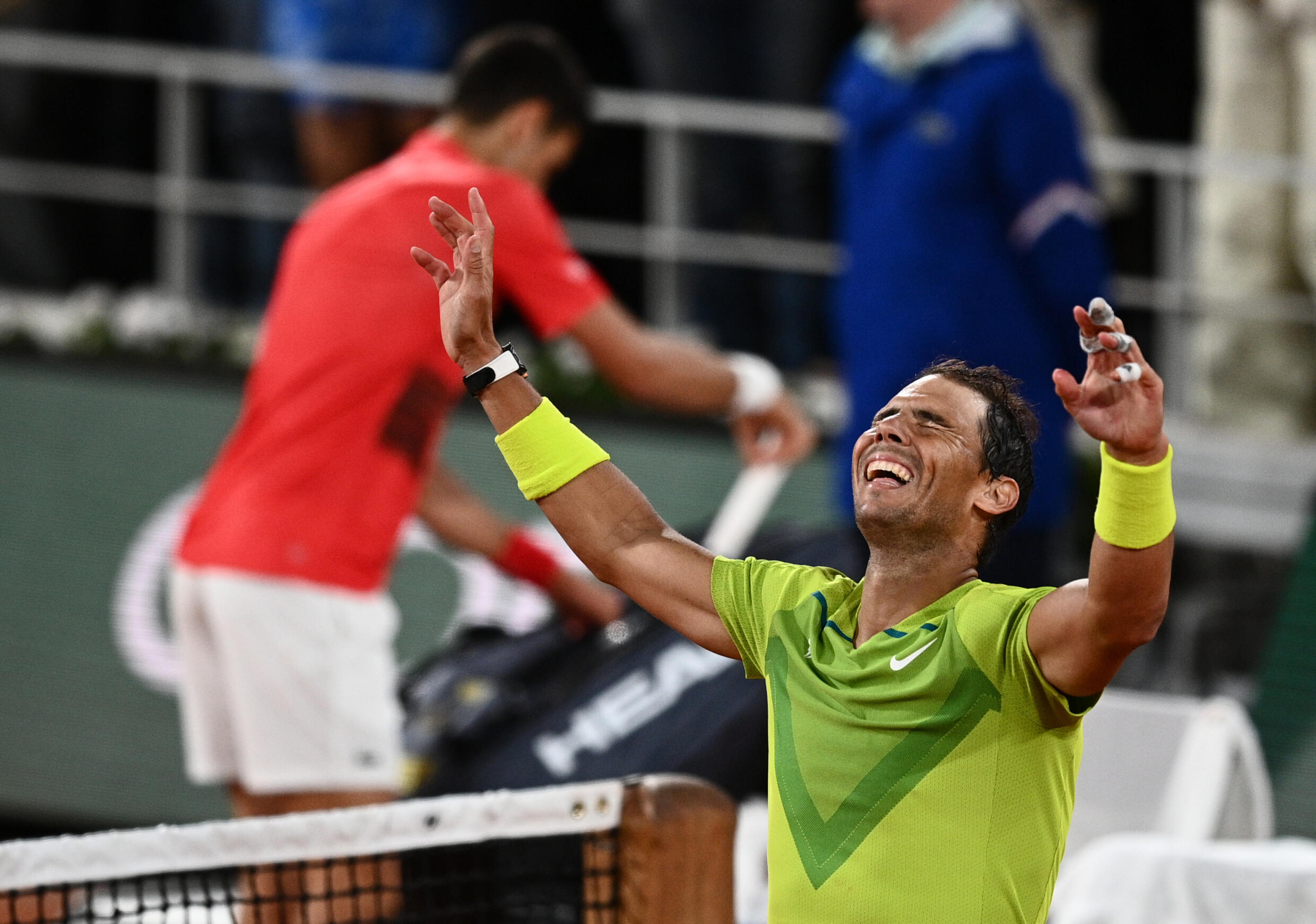 Spain's Rafael Nadal (D) reacts after winning against Serbian Novak Djokovic (L) at the end of their quarter-final match of Roland-Garros Open, in Paris, June 1, 2022