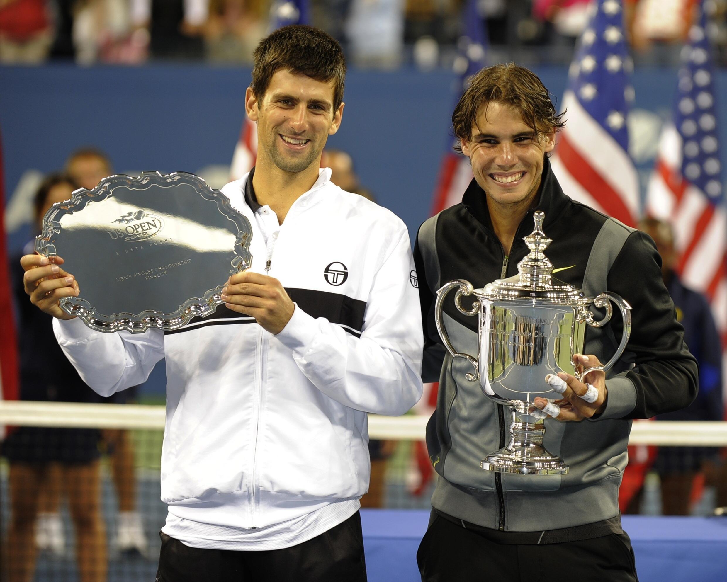 Spain's Rafael Nadal (R) and Serbia's Novak Djokovic present their trophies after Nadal won the final match at the 2010 US Open, in New York on September 13, 2010