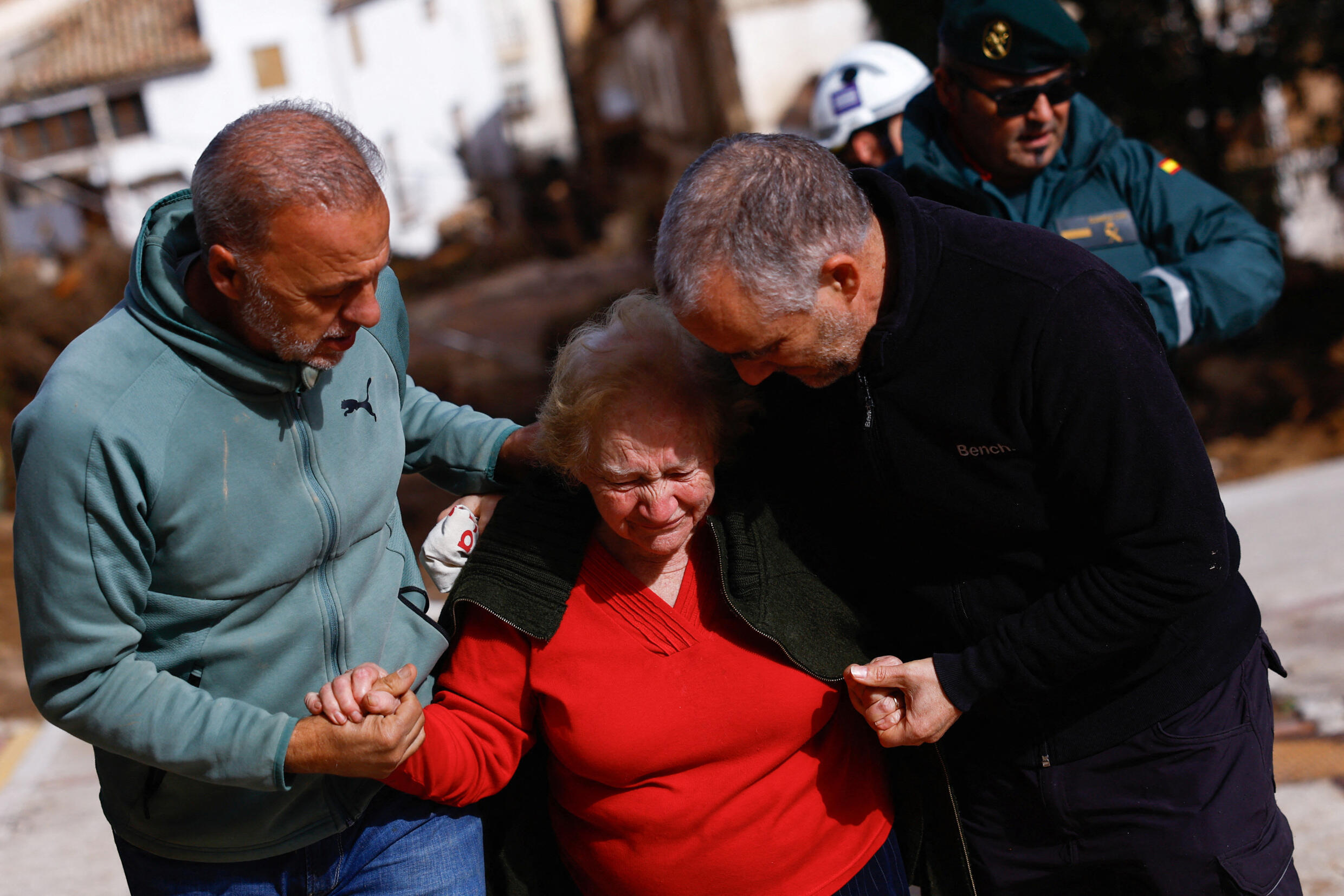 Encarna Rivero, 88, is taken in by her son and nephew after a nightmarish night, in Letur, October 30, 2024.