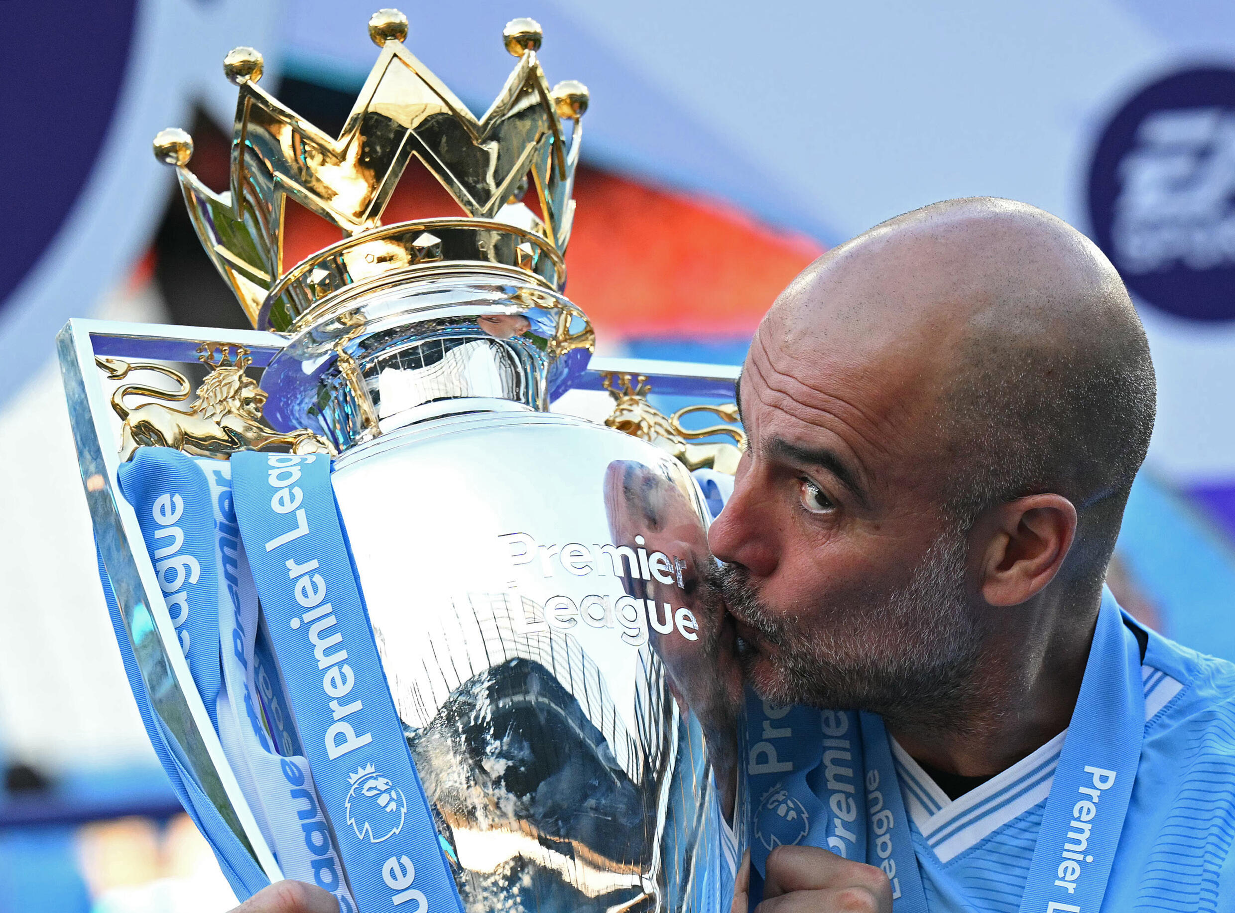 Spanish coach Pep Guardiola kisses the Premier League trophy won with Manchester City, May 19, 2024. He has just extended his contract with the northern English club for two more years, until 2027.