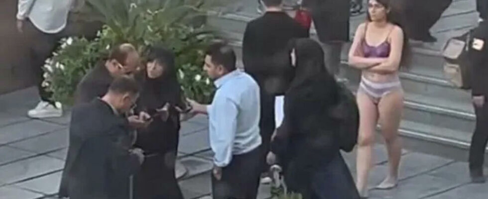 Student undresses in front of Tehran University in protest before