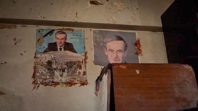 Torn photographs of former Syrian leaders still hung on the walls. 