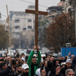 Christians in Damascus demonstrate after burning a Christmas tree to