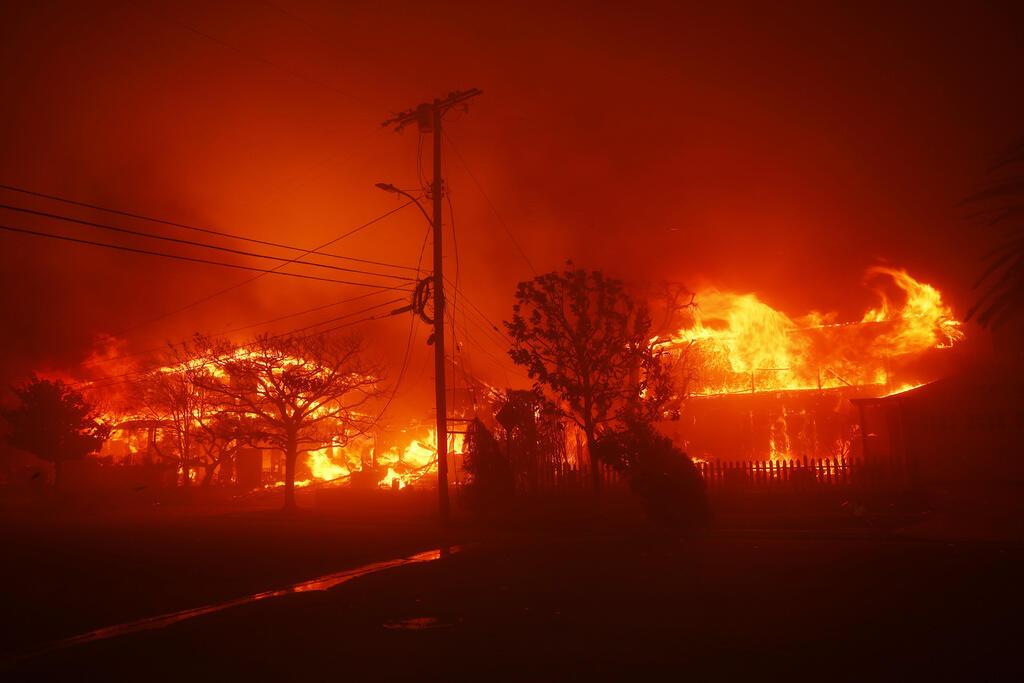 Several structures burn during a fire in the Pacific Palisades neighborhood of Los Angeles, Tuesday, January 7, 2025.