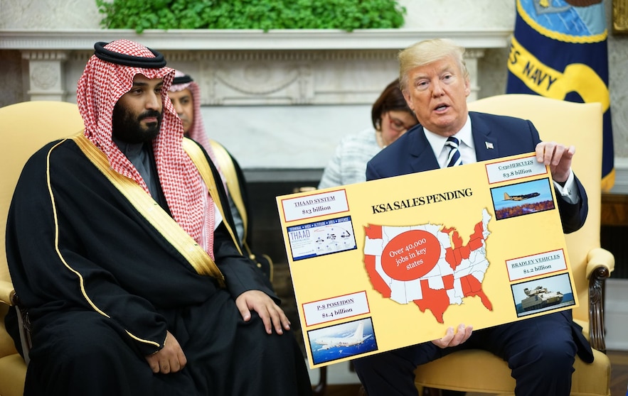 Donald Trump brandishes a painting with sales of arms to Saudi Arabia during his meeting with Saudi Crown Prince Mohammed bin Salmane