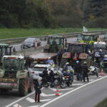 tractors surrounded by the police en route to Paris