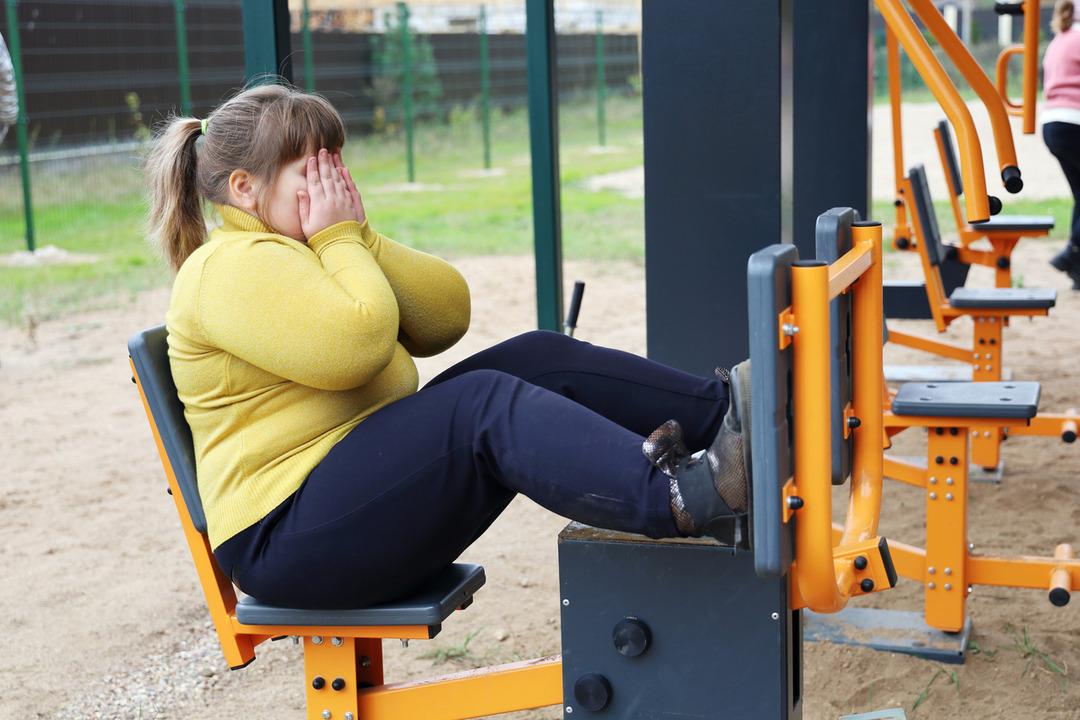 Overweight boy is doing sports